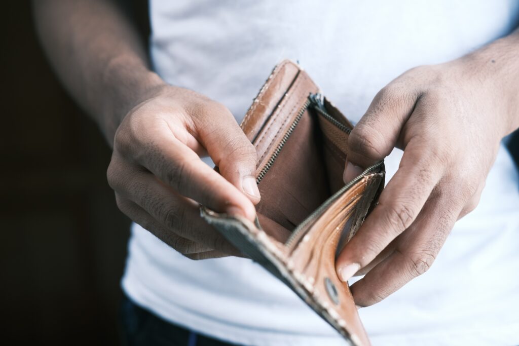 Man holding open an empty wallet